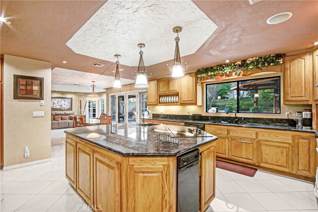 7954 Thoroughbred Street Rancho Cucamonga, CA 91701 - Photo 27 of 63 a kitchen with stainless steel appliances granite countertop a sink and a wooden cabinets