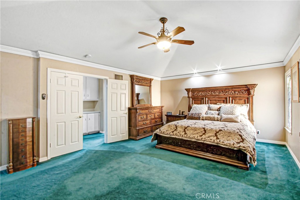 7954 Thoroughbred Street Rancho Cucamonga, CA 91701 - Photo 31 of 63 a bedroom with a bed and a chandelier