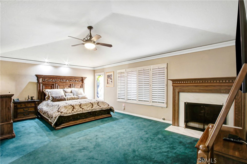 7954 Thoroughbred Street Rancho Cucamonga, CA 91701 - Photo 33 of 63 a bed room with a bed and a fireplace