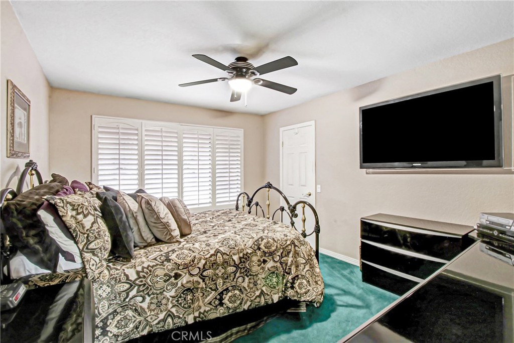 7954 Thoroughbred Street Rancho Cucamonga, CA 91701 - Photo 38 of 63 a bedroom with a bed and a flat screen tv