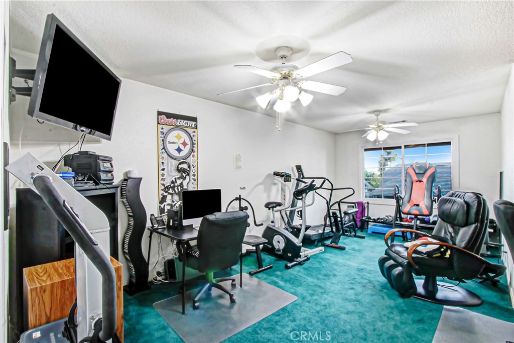 7954 Thoroughbred Street Rancho Cucamonga, CA 91701 - Photo 40 of 63 a view of a workspace with furniture and a flat screen tv