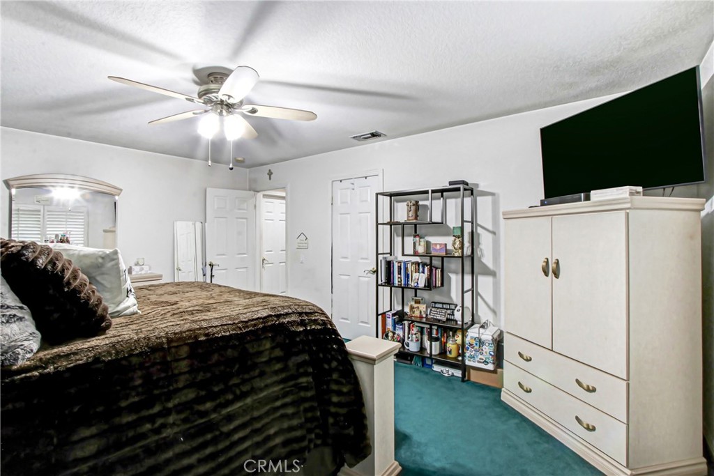 7954 Thoroughbred Street Rancho Cucamonga, CA 91701 - Photo 43 of 63 a bedroom with a bed and a flat screen tv