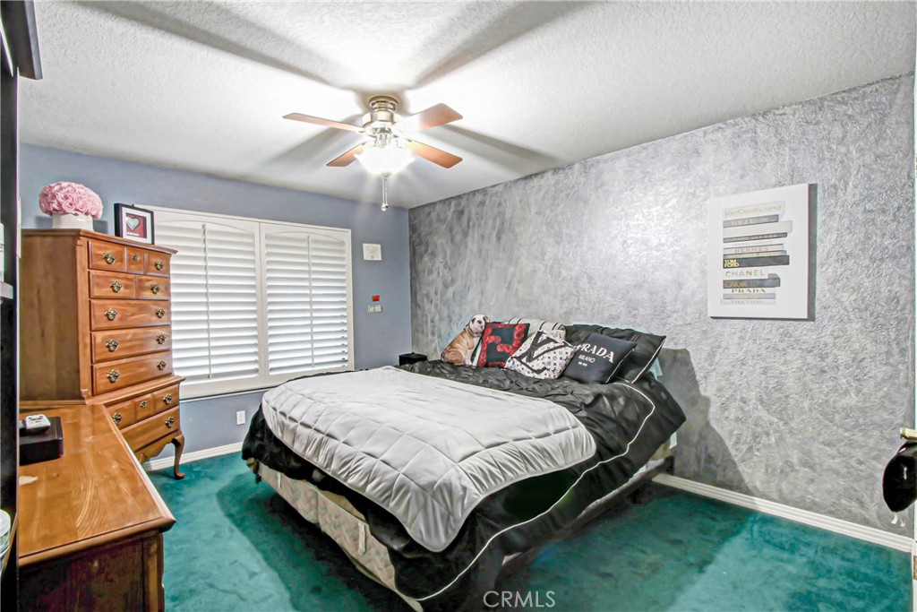 7954 Thoroughbred Street Rancho Cucamonga, CA 91701 - Photo 44 of 63 a bedroom with a bed and a chandelier