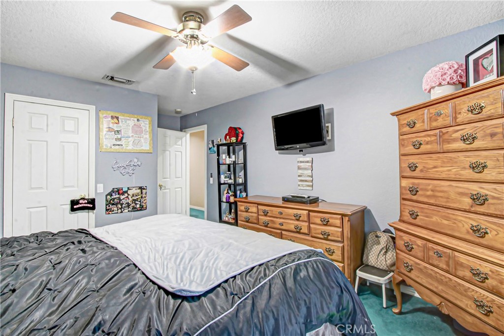 7954 Thoroughbred Street Rancho Cucamonga, CA 91701 - Photo 45 of 63 a bedroom with a bed and a flat screen tv