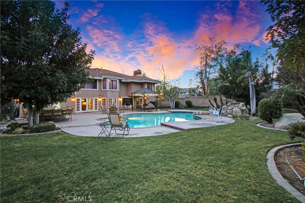 7954 Thoroughbred Street Rancho Cucamonga, CA 91701 - Photo 51 of 63 a view of a house with a big yard potted plants and large trees