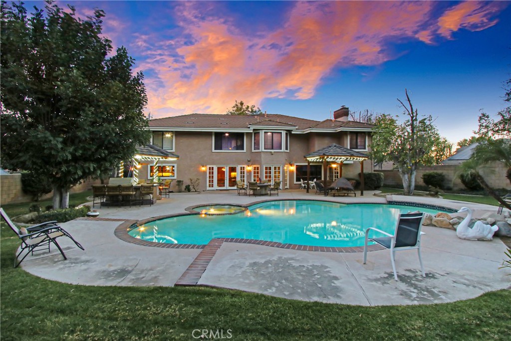 7954 Thoroughbred Street Rancho Cucamonga, CA 91701 - Photo 52 of 63 a front view of a house with swimming pool having outdoor seating