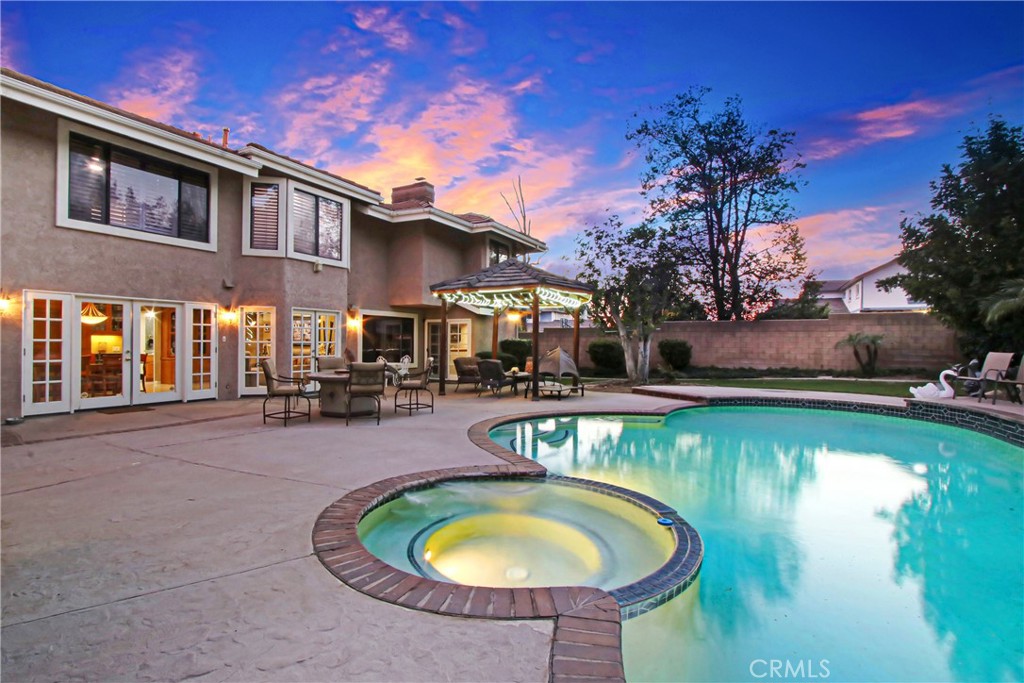 7954 Thoroughbred Street Rancho Cucamonga, CA 91701 - Photo 56 of 63 a swimming pool with outdoor seating and yard