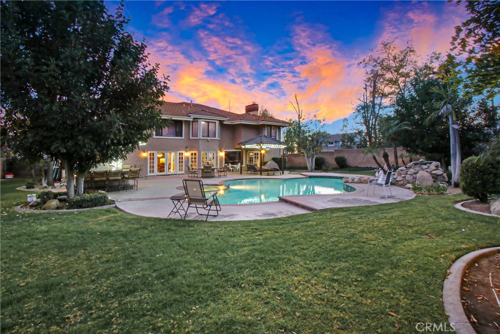 7954 Thoroughbred Street Rancho Cucamonga, CA 91701 - Photo 58 of 63 a view of a house with a backyard porch and sitting area
