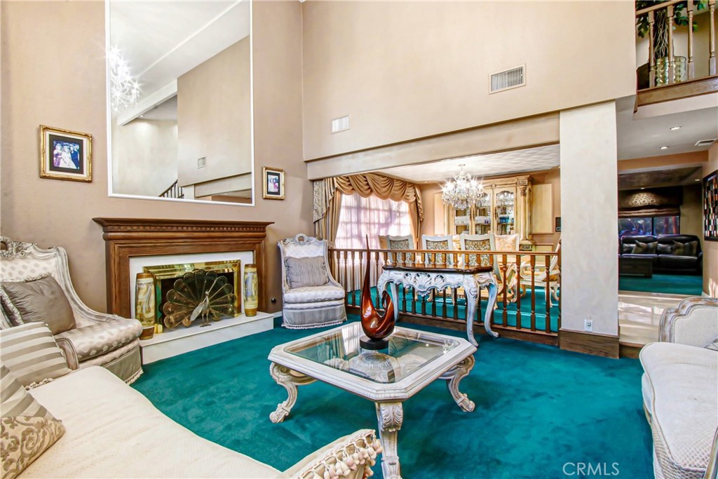 7954 Thoroughbred Street Rancho Cucamonga, CA 91701 - Photo 8 of 63 a living room with furniture a fireplace and a table