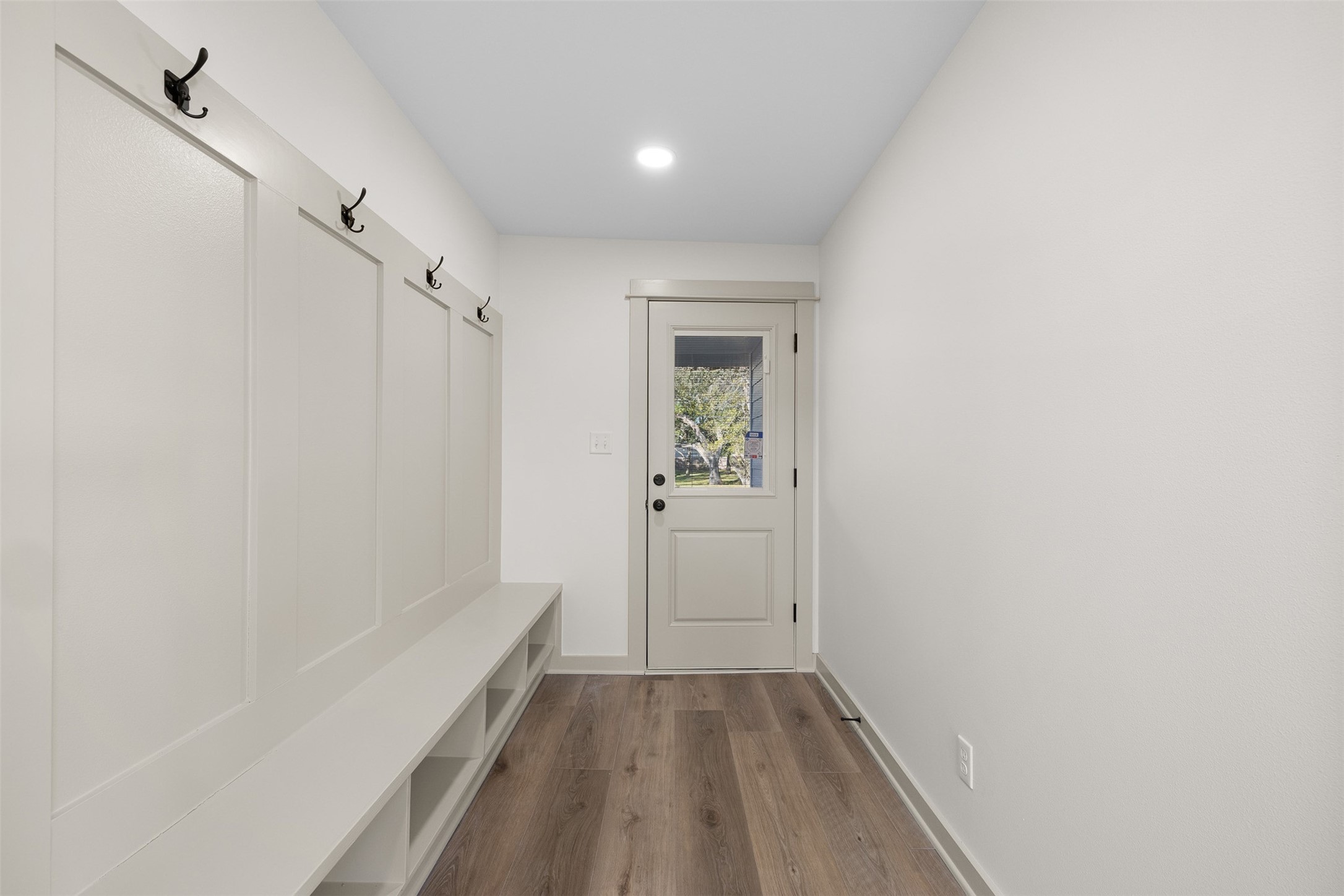 911 Eilers Street Schulenburg, TX 78956 - Photo 18 of 22 a view of a hallway with wooden floor and a bathroom