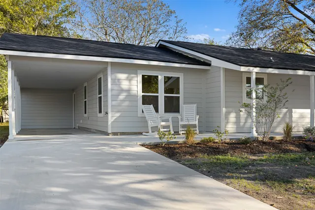 a backyard of a house with yard and outdoor seating