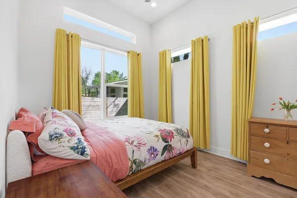 a bedroom with a bed and wooden floor