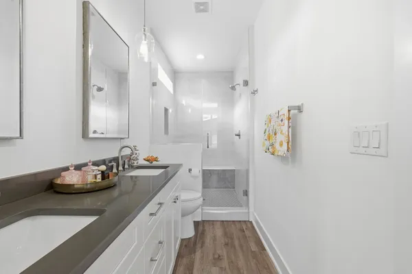 a bathroom with a sink mirror and shower