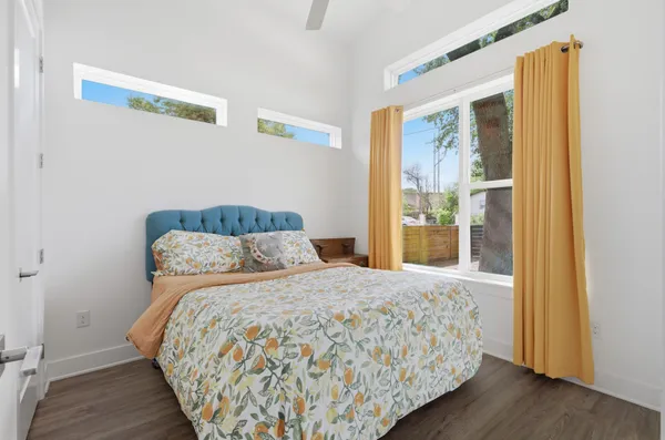 a bedroom with a bed and wooden floor