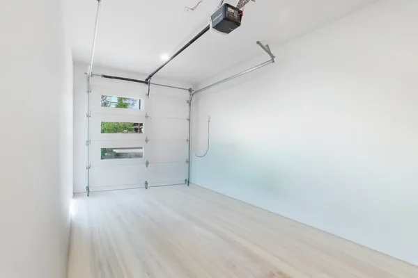 a view of empty room with wooden floor
