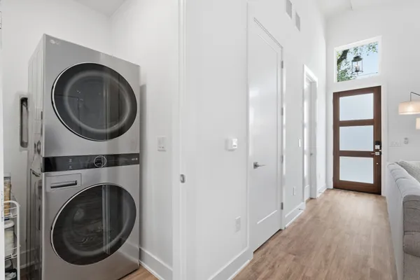 a view of a hallway with washer and dryer