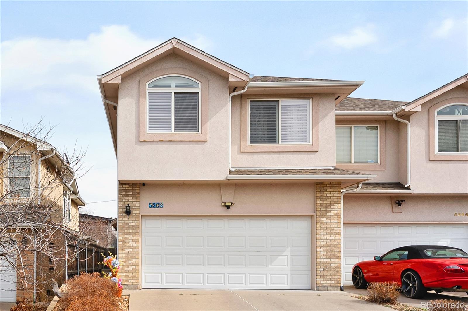 a front view of a house with parking space