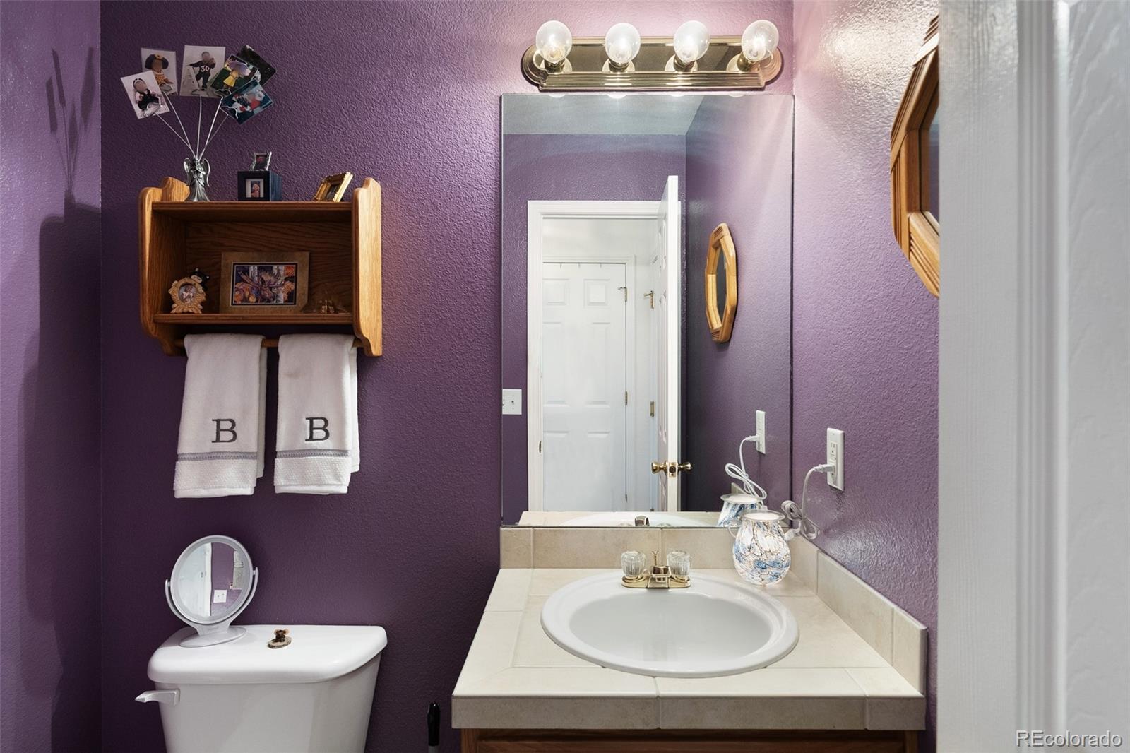 5308 Stuart Street Denver, CO 80212 - Photo 12 of 33 a bathroom with a toilet sink and mirror