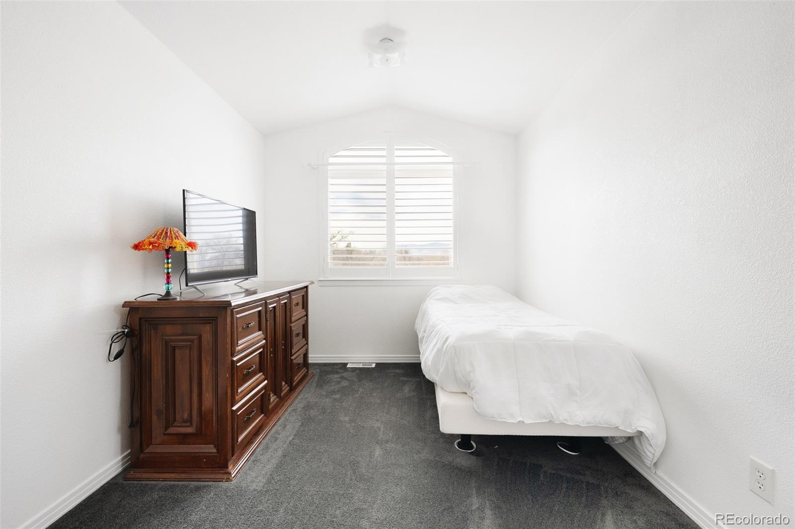 5308 Stuart Street Denver, CO 80212 - Photo 19 of 33 a bedroom with a bed and wooden floor