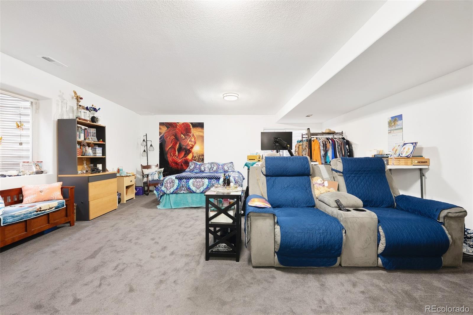 5308 Stuart Street Denver, CO 80212 - Photo 21 of 33 a living room with furniture and a flat screen tv