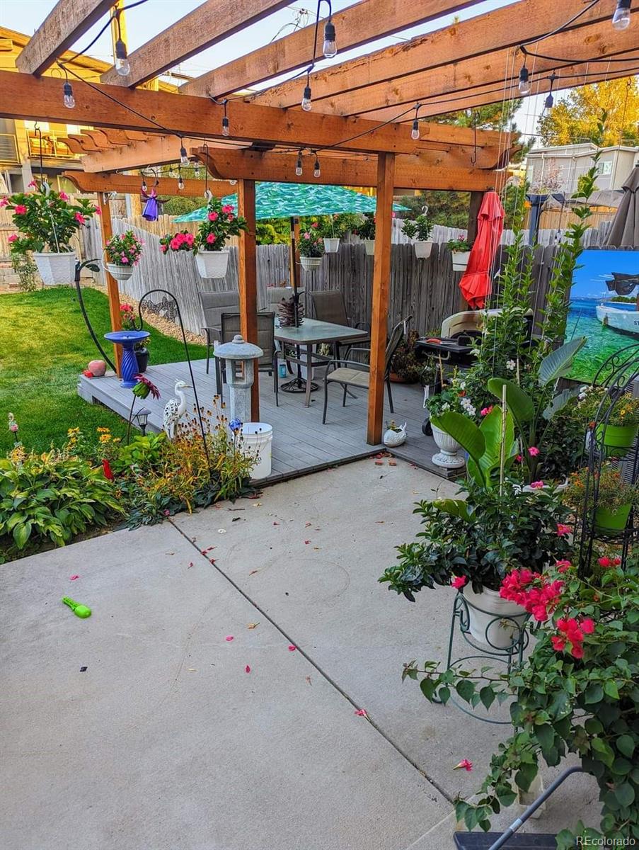 5308 Stuart Street Denver, CO 80212 - Photo 29 of 33 a view of a patio with a table and chairs and potted plants