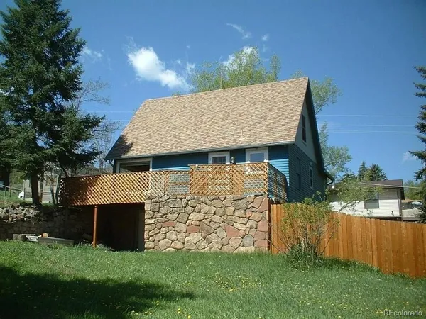 a view of a house with brick walls