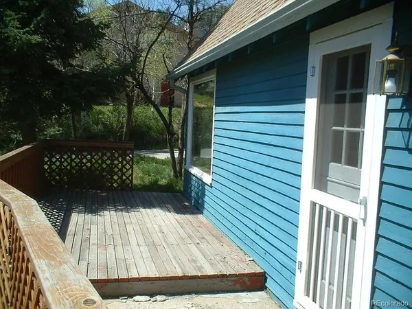 a view of backyard with a deck