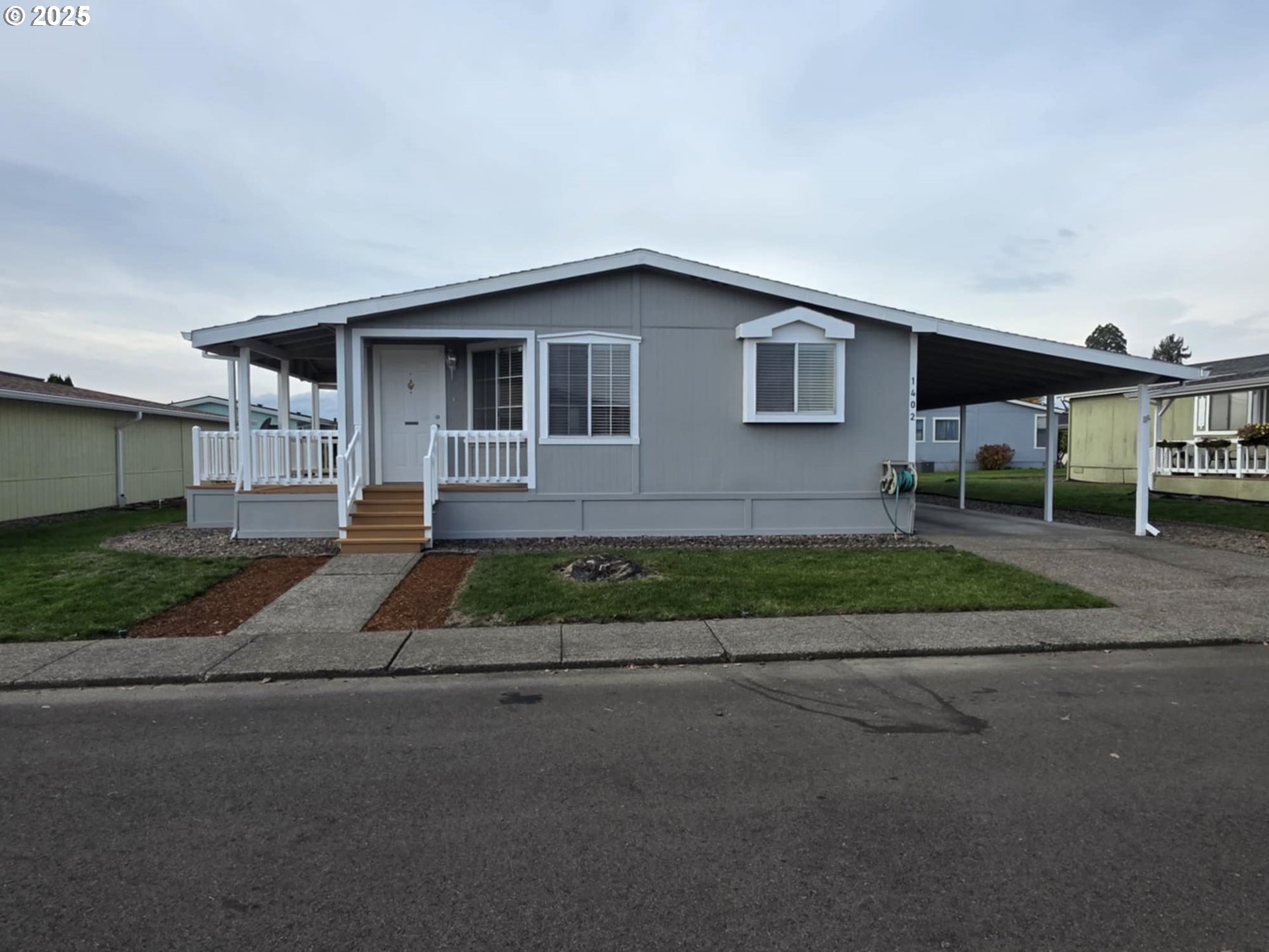 1402 Pioneer Way Forest Grove, OR 97116 - Photo 1 of 26 a front view of a house with a yard and garage