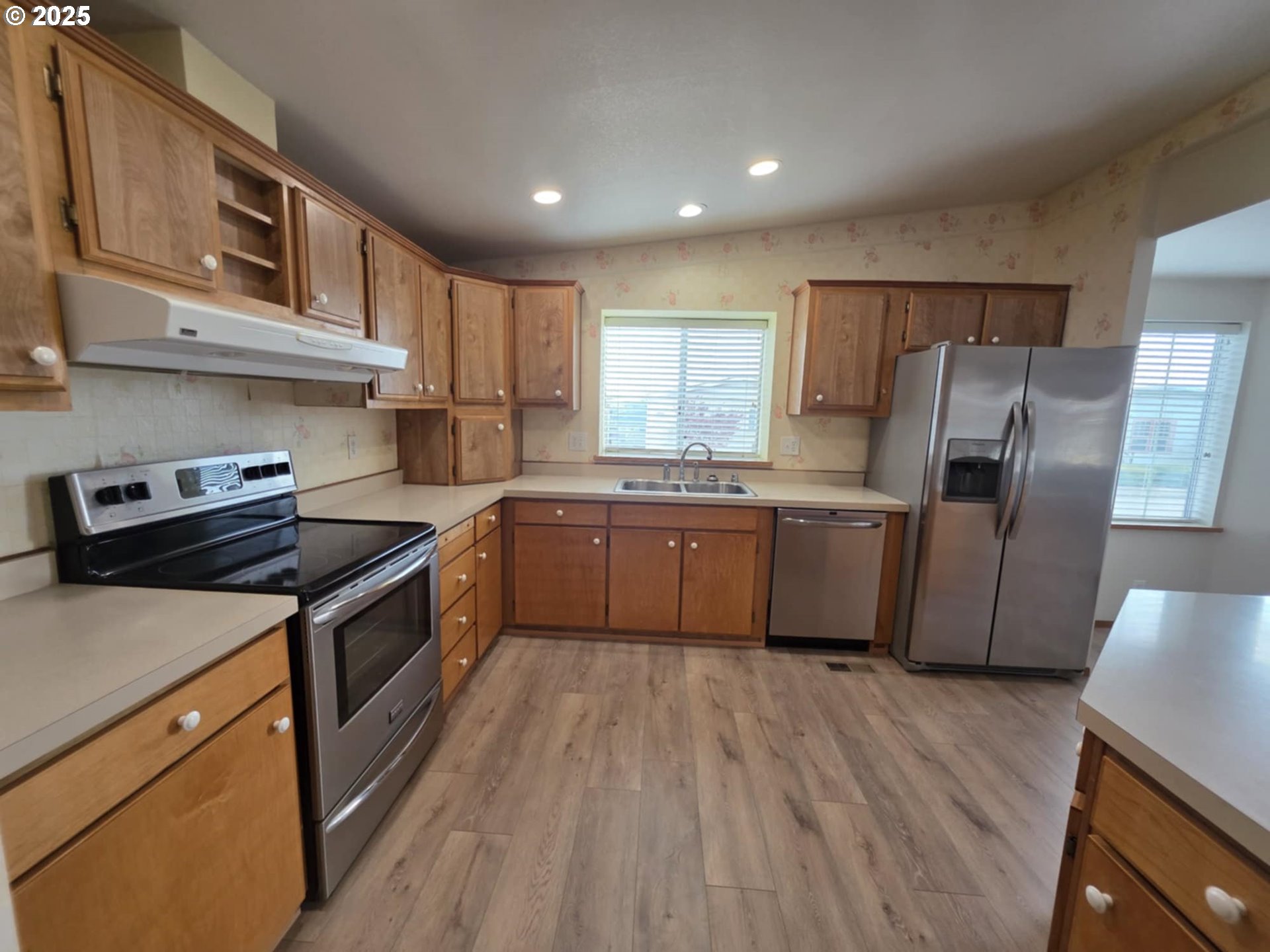 1402 Pioneer Way Forest Grove, OR 97116 - Photo 11 of 26 a kitchen with stainless steel appliances granite countertop a stove a sink dishwasher a refrigerator and a wooden cabinets with wooden floor