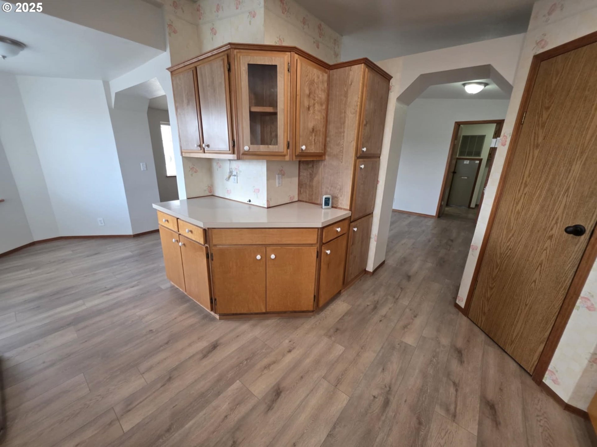 1402 Pioneer Way Forest Grove, OR 97116 - Photo 13 of 26 a room with stainless steel appliances wooden floors and wooden cabinets