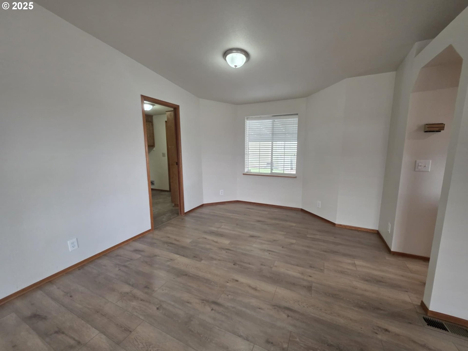 1402 Pioneer Way Forest Grove, OR 97116 - Photo 14 of 26 an empty room with wooden floor and windows