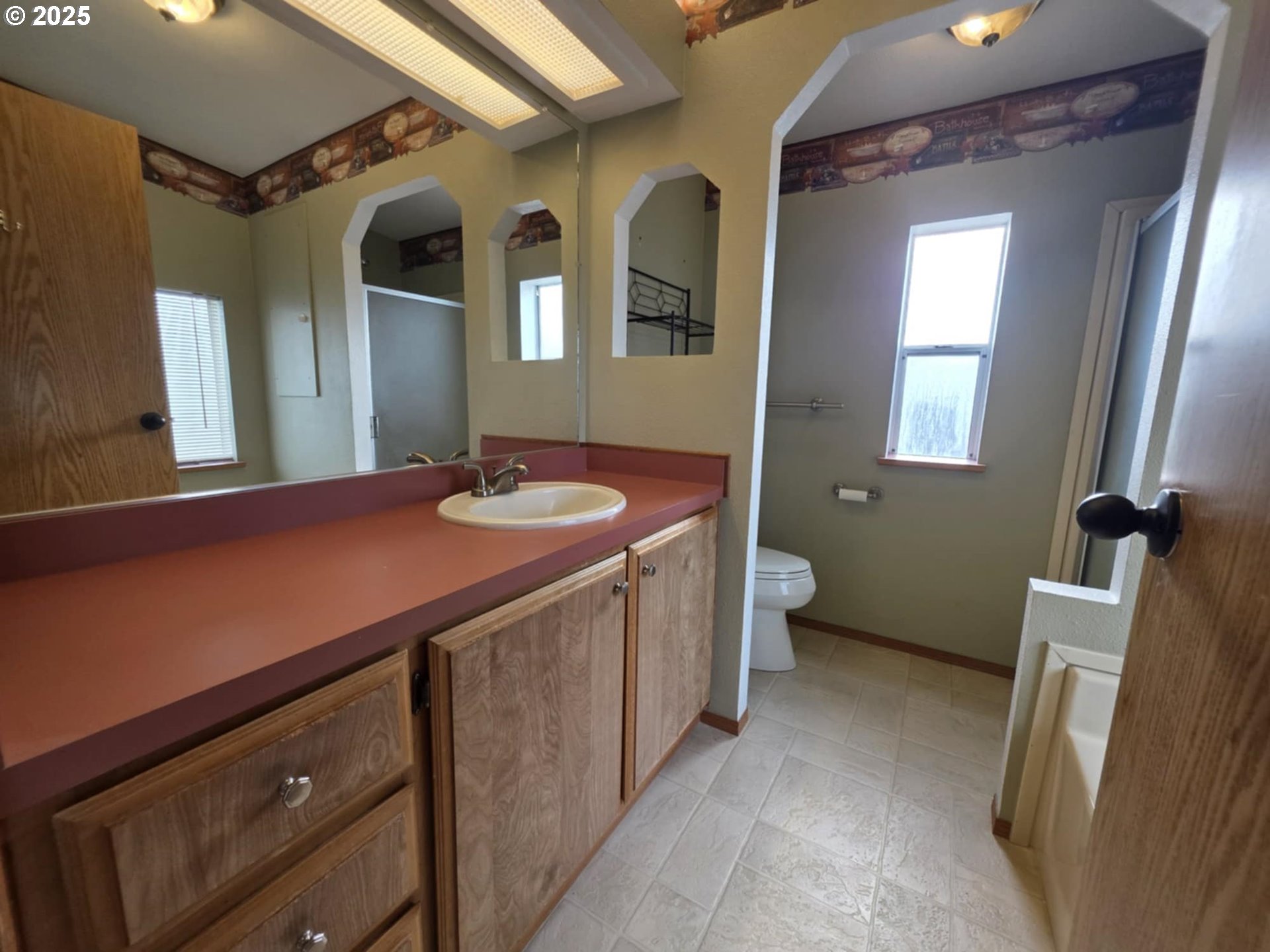 1402 Pioneer Way Forest Grove, OR 97116 - Photo 23 of 26 a bathroom with a sink a toilet a mirror and vanity