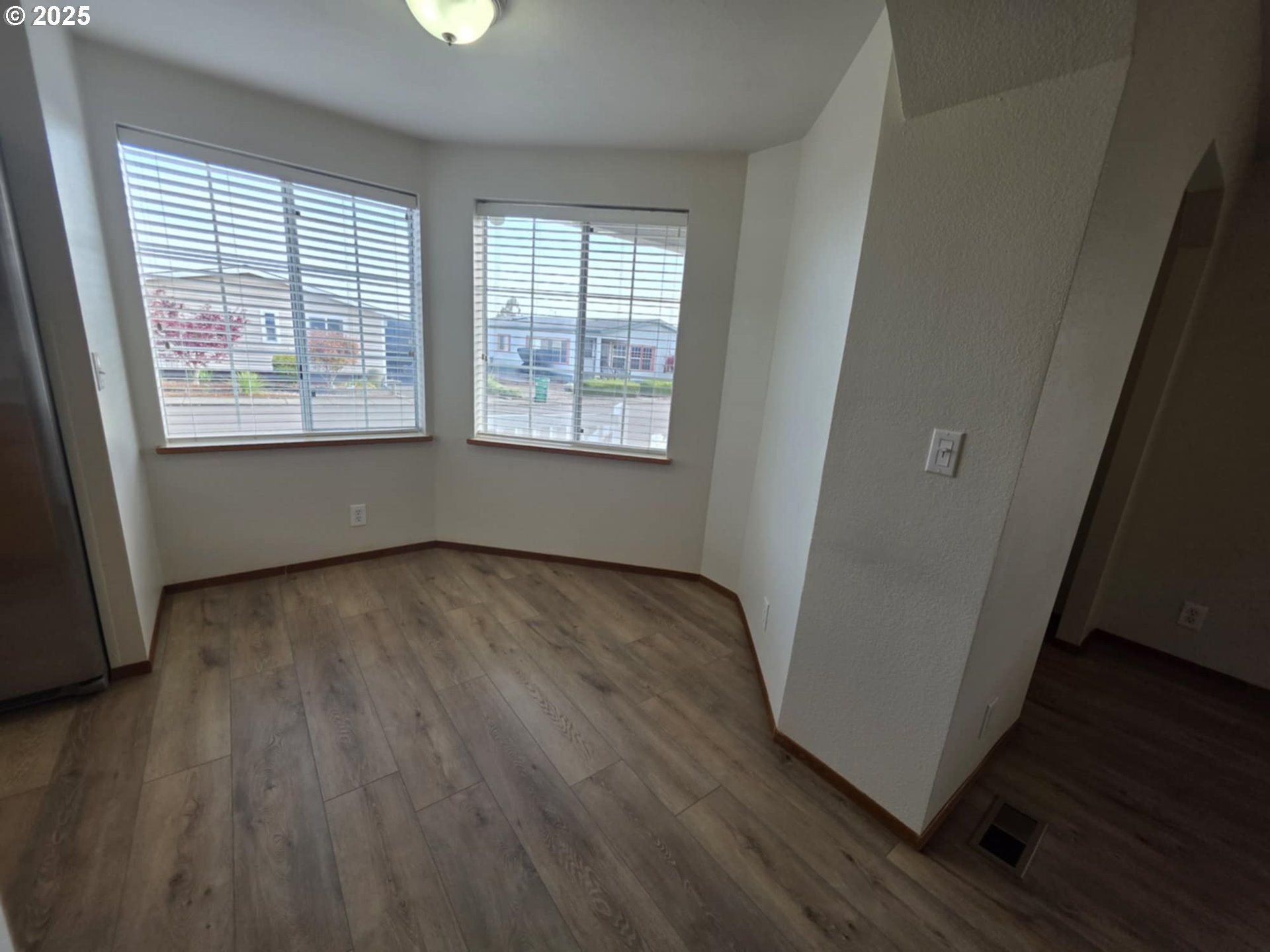 1402 Pioneer Way Forest Grove, OR 97116 - Photo 9 of 26 an empty room with wooden floor and windows