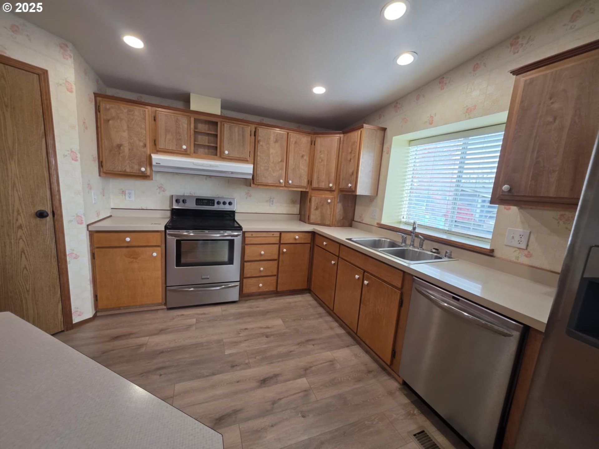 1402 Pioneer Way Forest Grove, OR 97116 - Photo 10 of 26 a kitchen with stainless steel appliances granite countertop a stove sink and cabinets