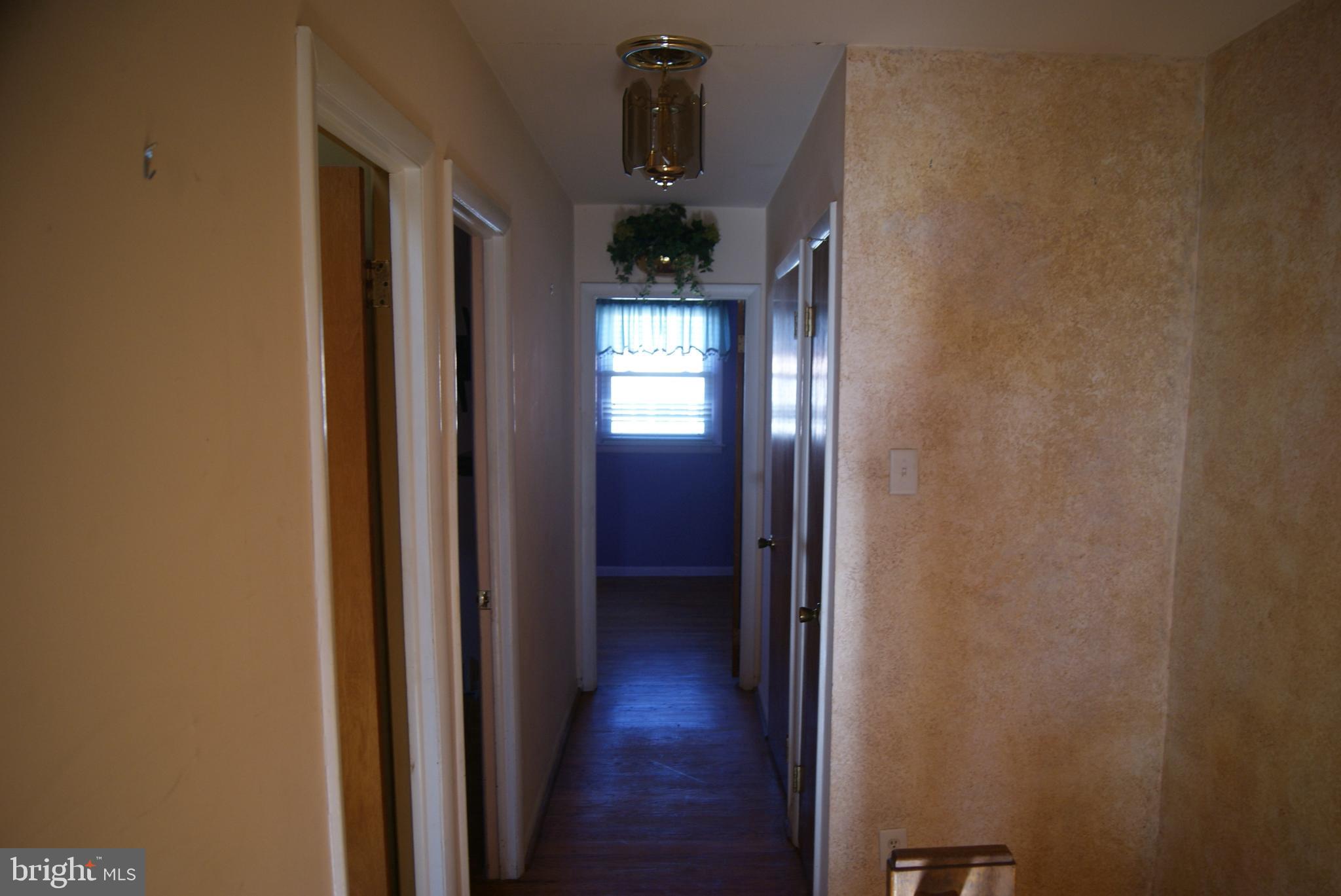 7314 Hill Road Philadelphia, PA 19128 - Photo 21 of 68 a view of a hallway with wooden floor and stairs