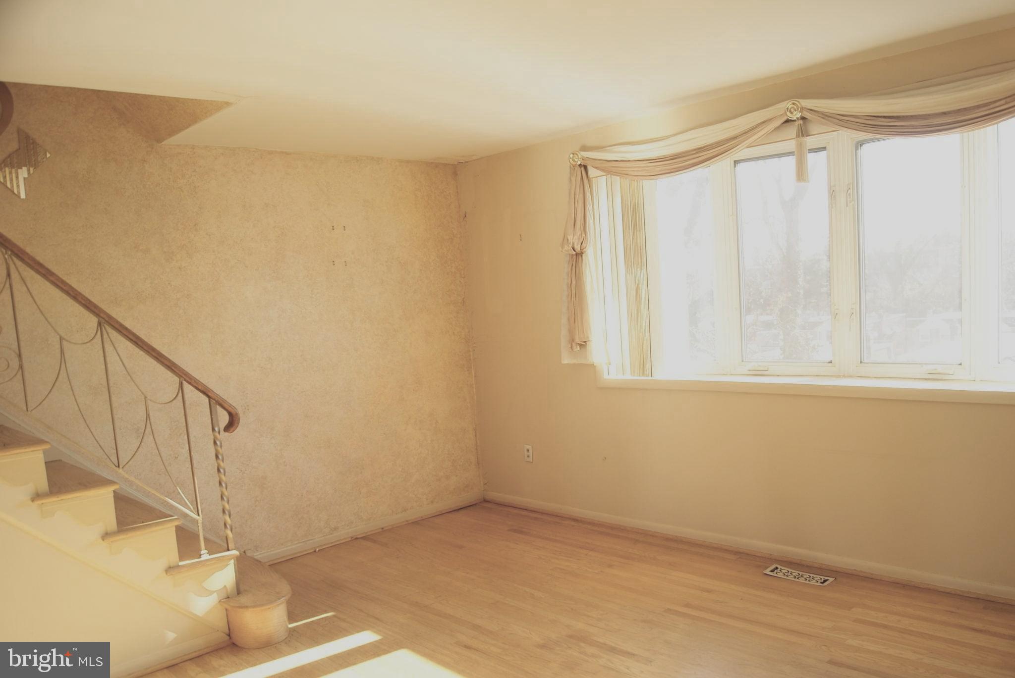 7314 Hill Road Philadelphia, PA 19128 - Photo 26 of 68 a view of an empty room with wooden floor and stairs