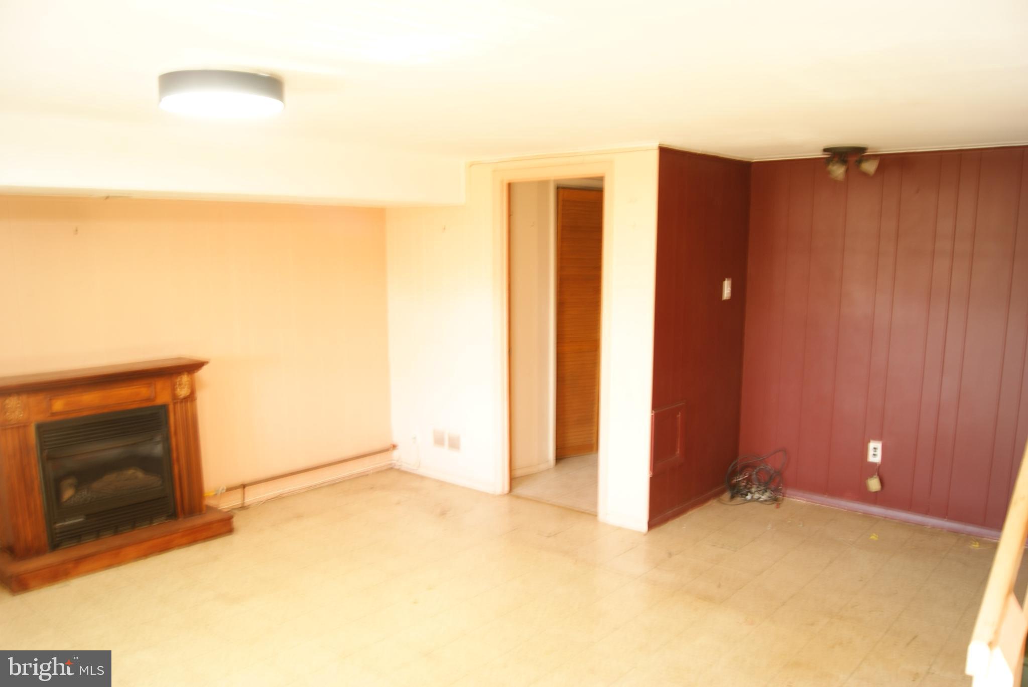 7314 Hill Road Philadelphia, PA 19128 - Photo 31 of 68 a view of an empty room with wooden floor and a fireplace