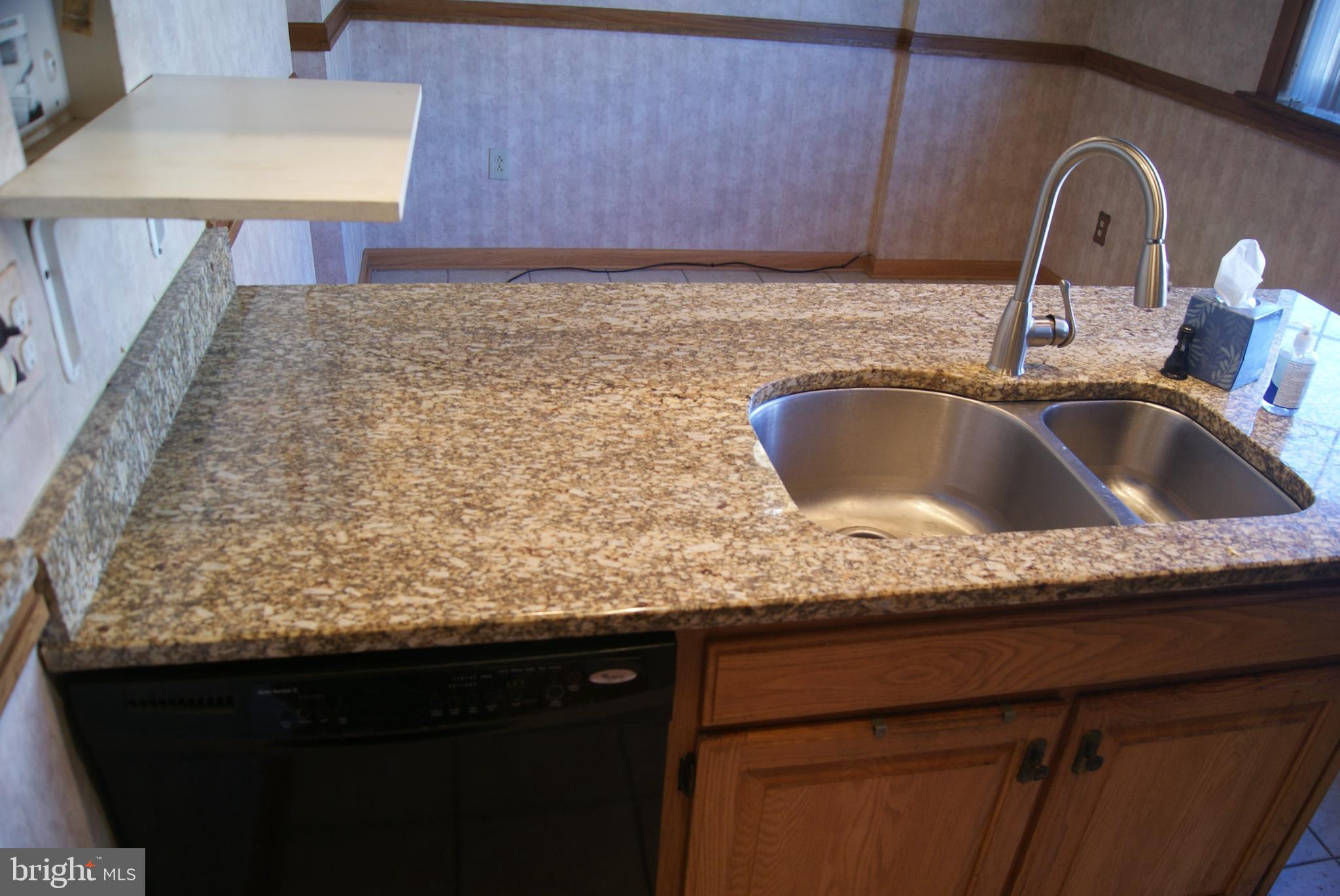 7314 Hill Road Philadelphia, PA 19128 - Photo 6 of 68 a kitchen with granite countertop a sink and a wooden cabinets