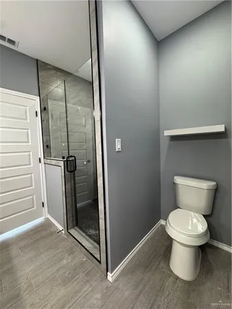 an empty room with windows and fan view