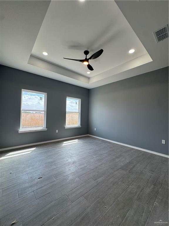17962 Redwood Street Harlingen, TX 78552 - Photo 11 of 14 an empty room with wooden floor and windows