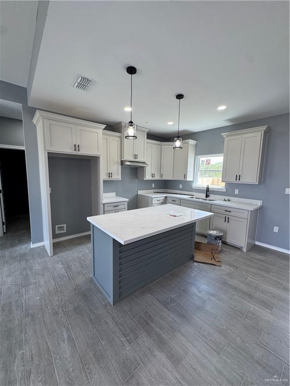 17962 Redwood Street Harlingen, TX 78552 - Photo 2 of 14 a large kitchen with kitchen island a sink stainless steel appliances and cabinets
