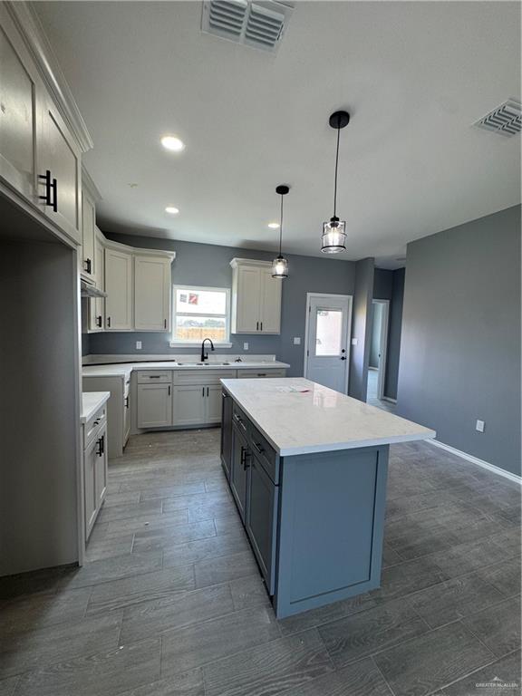 17962 Redwood Street Harlingen, TX 78552 - Photo 3 of 14 a large kitchen with kitchen island a sink stainless steel appliances and cabinets