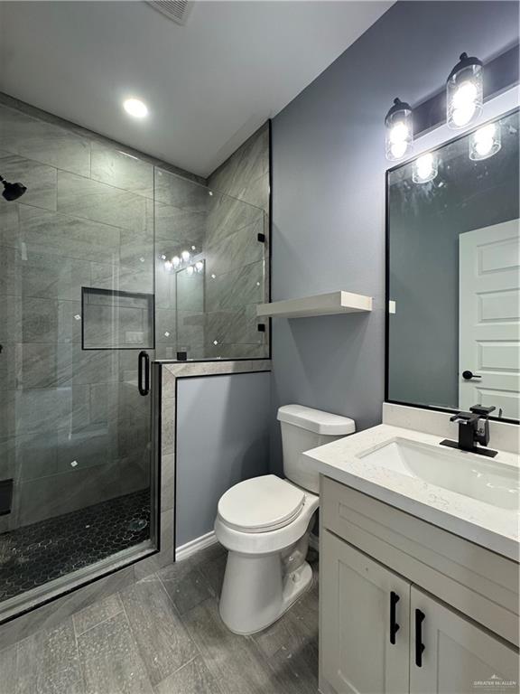 17962 Redwood Street Harlingen, TX 78552 - Photo 6 of 14 a bathroom with a sink a toilet and shower