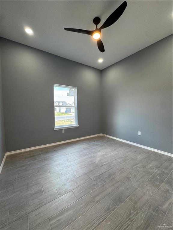 17962 Redwood Street Harlingen, TX 78552 - Photo 7 of 14 an empty room with windows and fan view