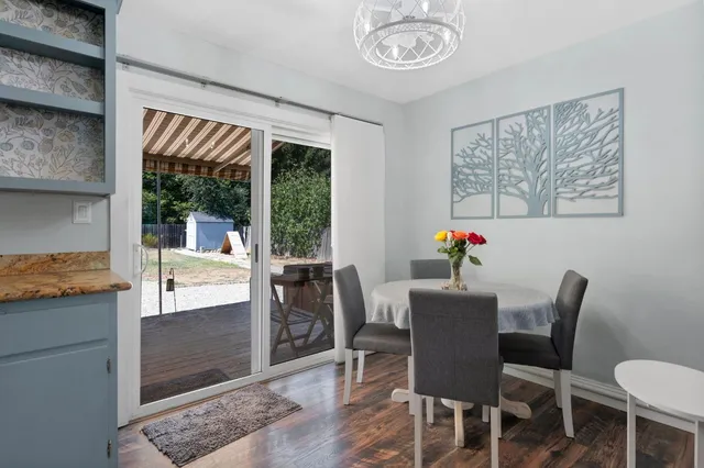 a kitchen with granite countertop a sink a stove and cabinets