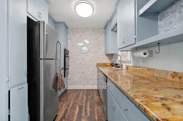 a bedroom that has a bed plant and a table in it