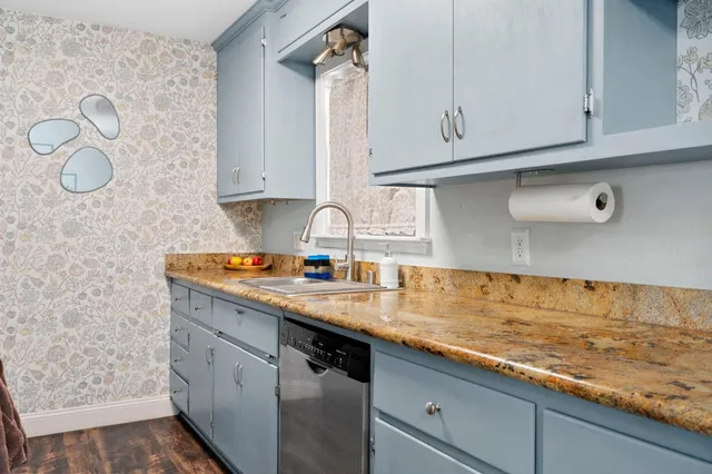 a bathroom with a sink vanity mirror and toilet