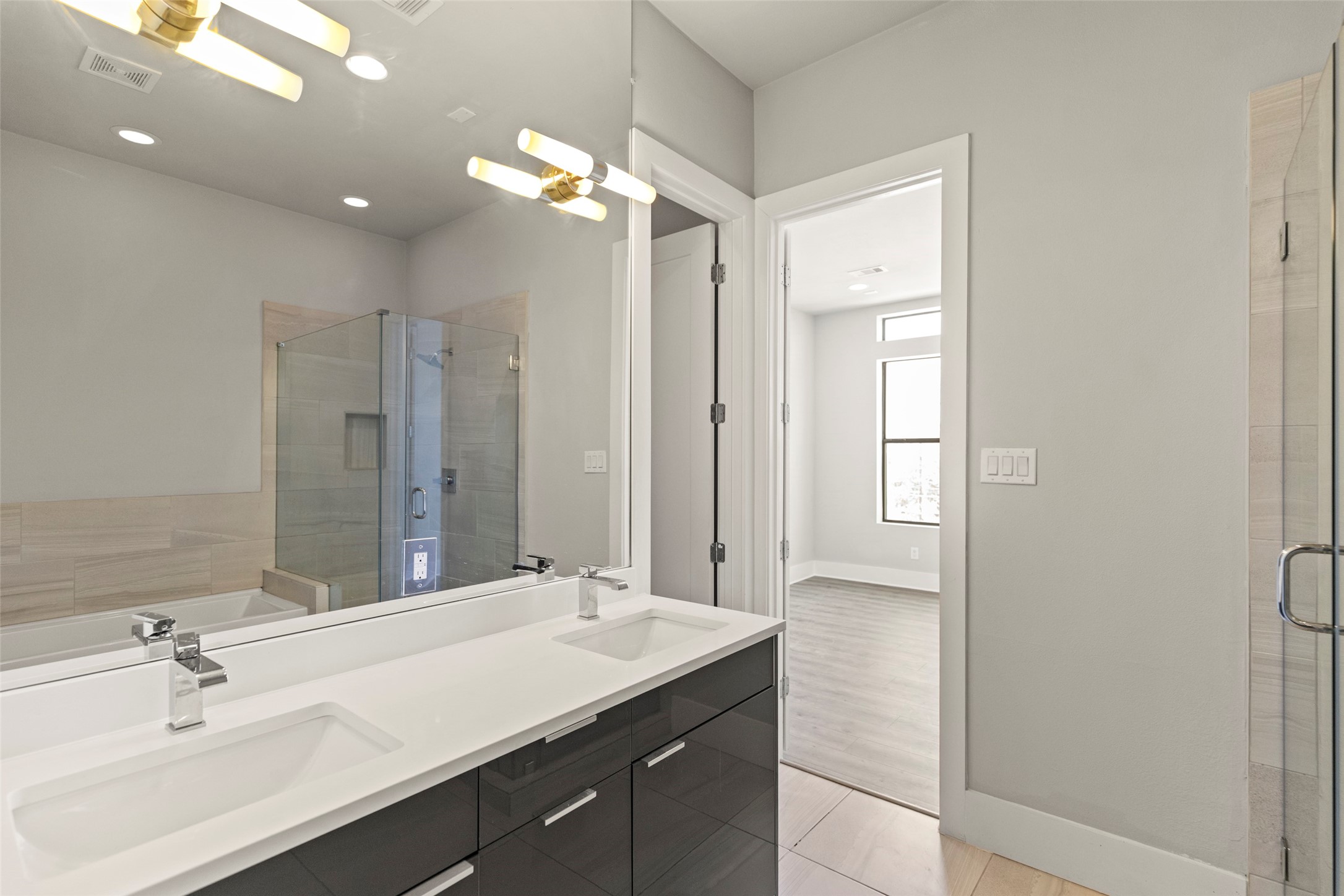 1613 Wheeler Avenue, Unit A Houston, TX 77004 - Photo 16 of 32 a bathroom with a sink double vanity and a mirror