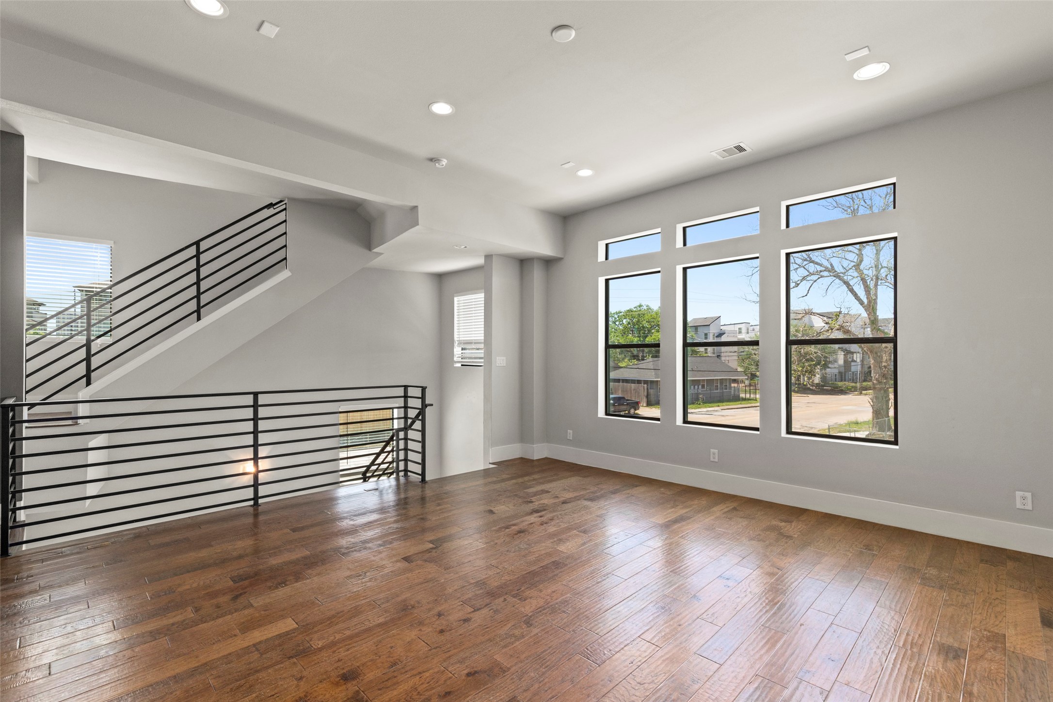 1613 Wheeler Avenue, Unit A Houston, TX 77004 - Photo 5 of 32 a view of empty room with wooden floor and fan