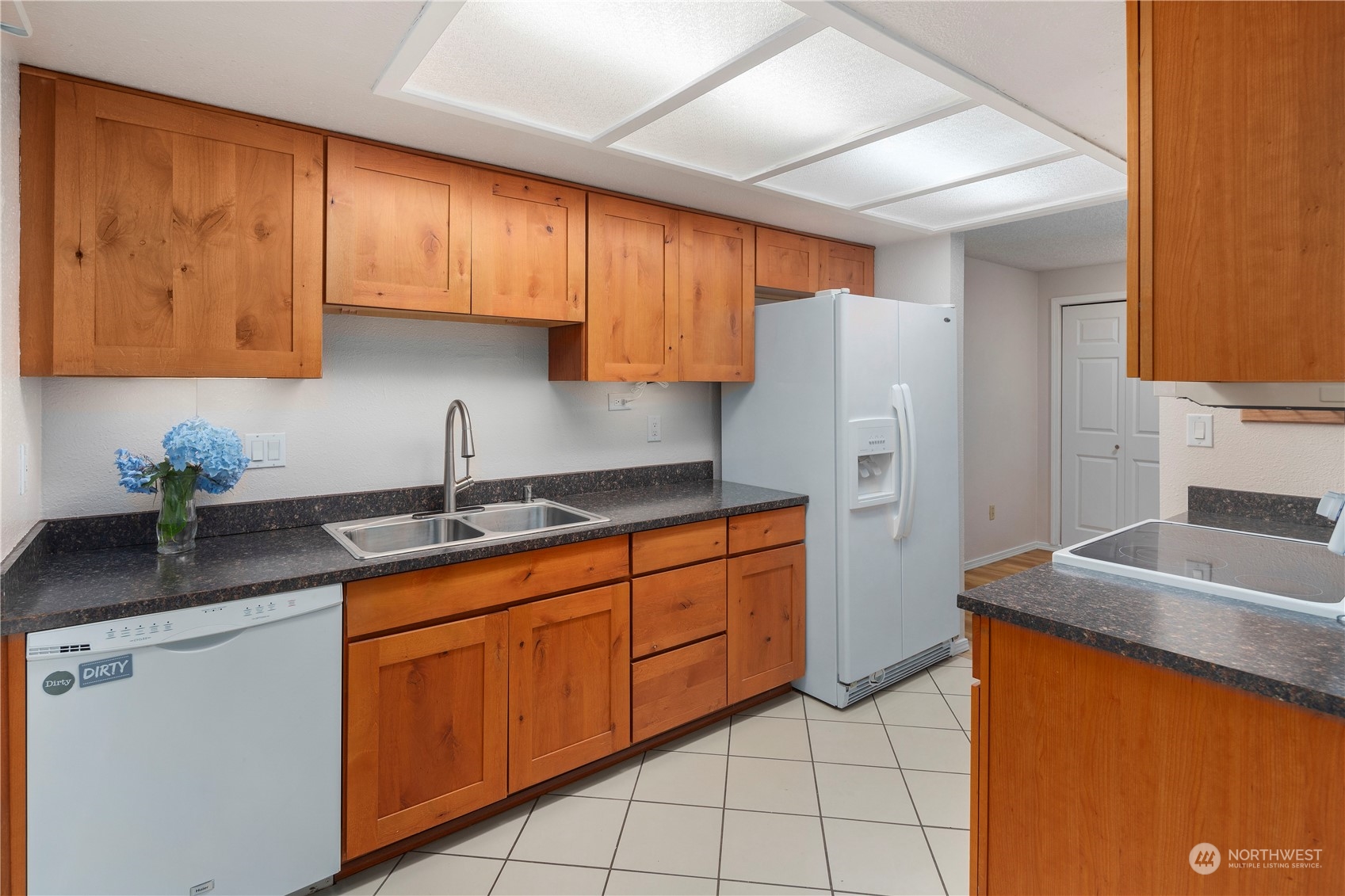 17522 151st Avenue Southeast, Unit 31 Renton, WA 98058 - Photo 17 of 37 a kitchen with stainless steel appliances granite countertop a sink stove and refrigerator